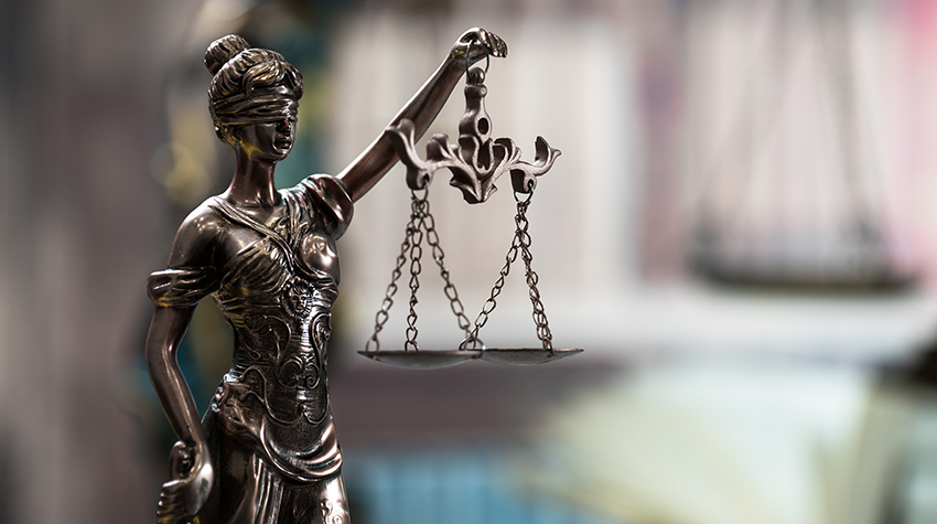 Legal image of lady justice holding weights