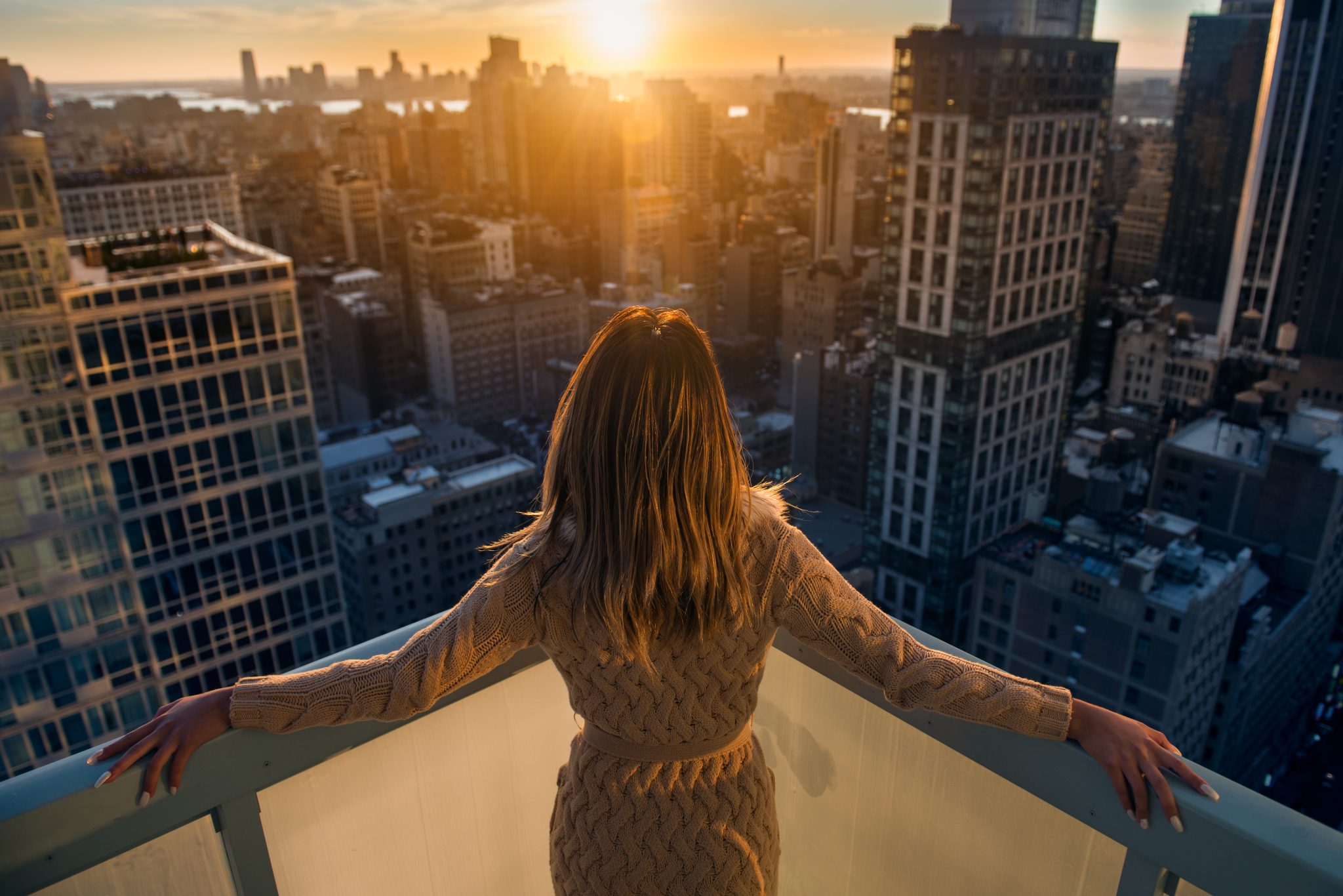 Legal lifestyle image of woman looking out at city view